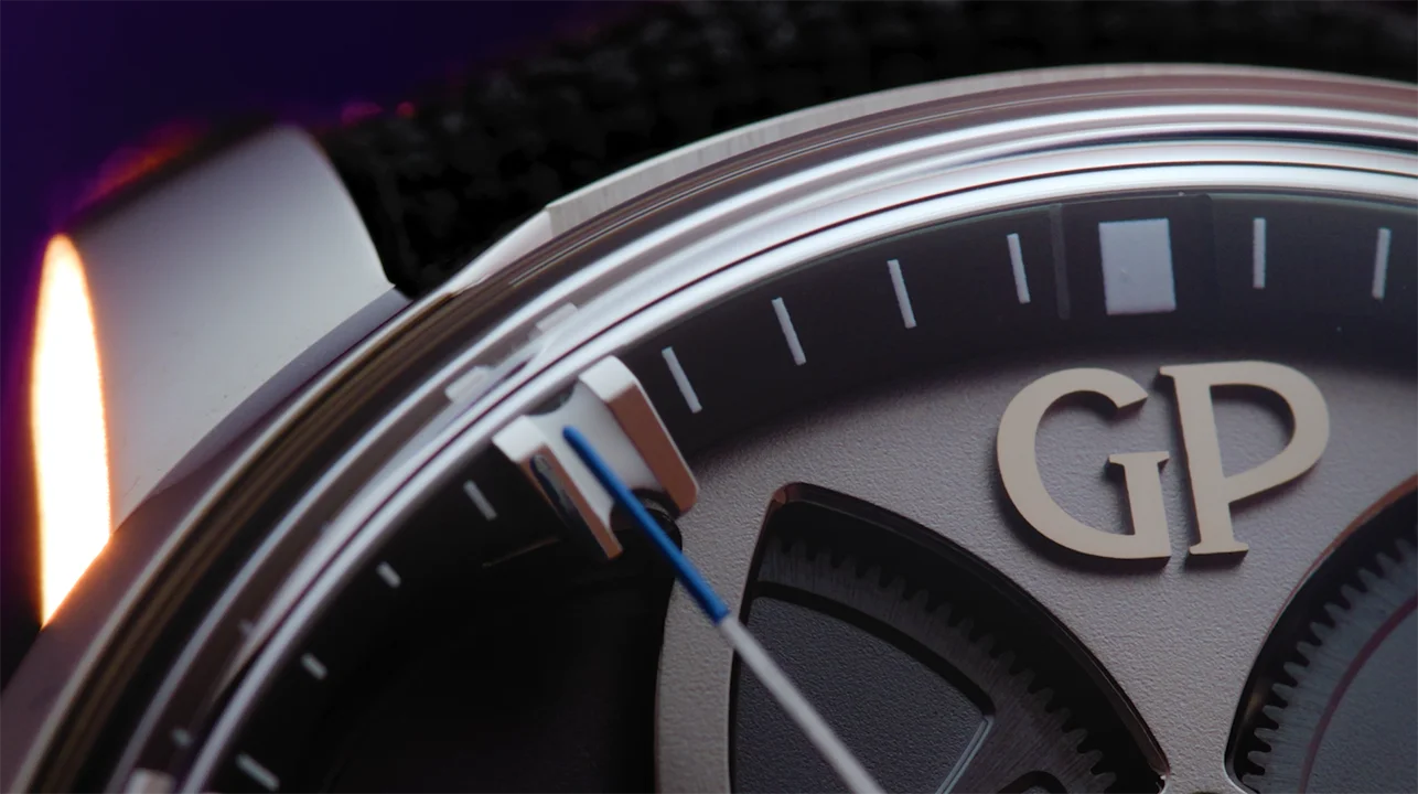 Cornland Studio - gros plan d'un candrant de montre sur fond violet avec un logo Girard-perregaux